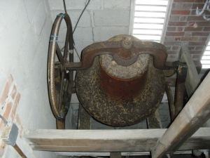 Bell sits in unstable cast iron standards.